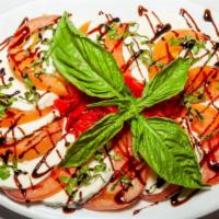 Mozzarella Caprese Salad · Fresh mozzarella, roasted red peppers, fresh tomatoes, balsamic glaze and basil.