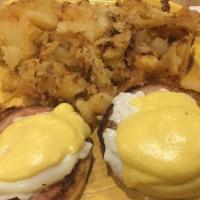 Eggs Benedict · 2 poached eggs on a toasted English muffin with Canadian bacon and hollandaise sauce, served...