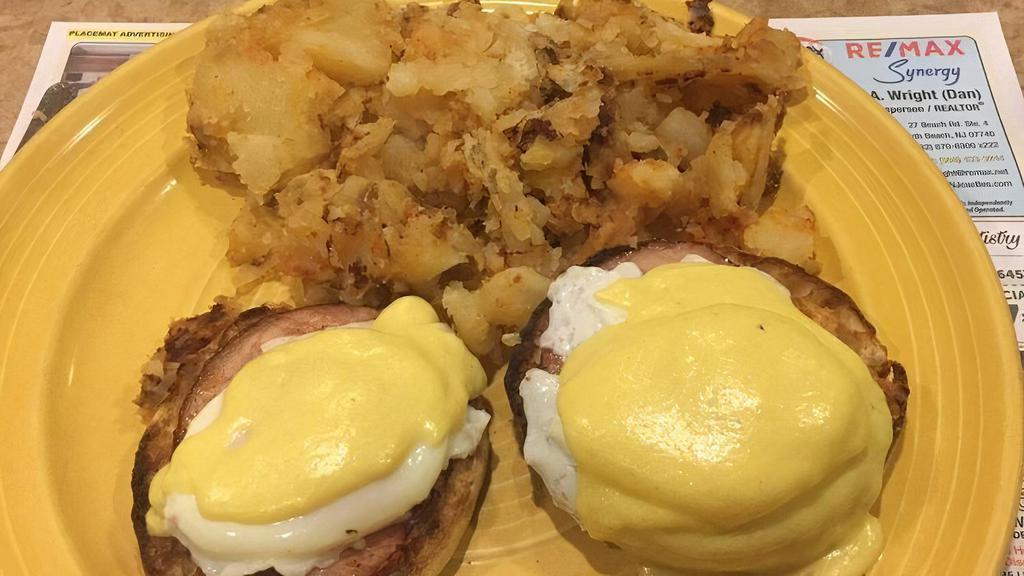 Eggs Benedict · 2 poached eggs on a toasted English muffin with Canadian bacon and hollandaise sauce, served with home fries.