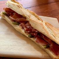 Serrano Beurre · Cured ham, pickles butter on the baguette.