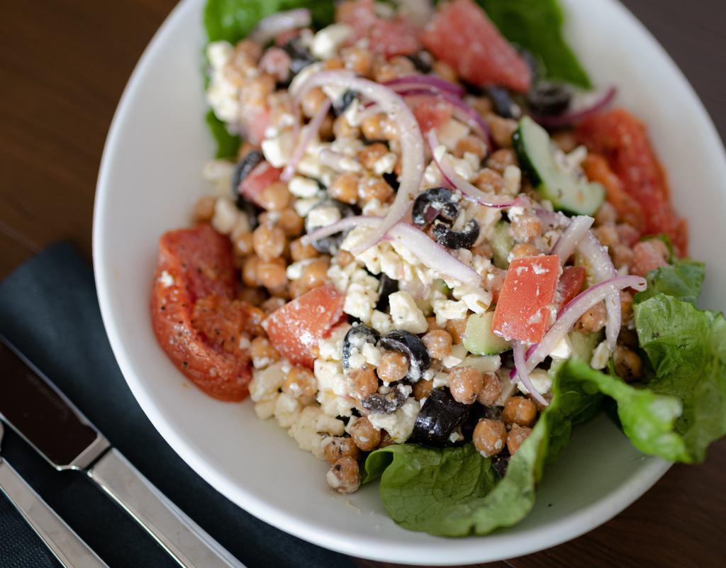 Chickpea Mediterranean Salad · Roasted chickpeas, tomato, red onions, peppers, black olives, and feta cheese drizzled in a lemon dressing.