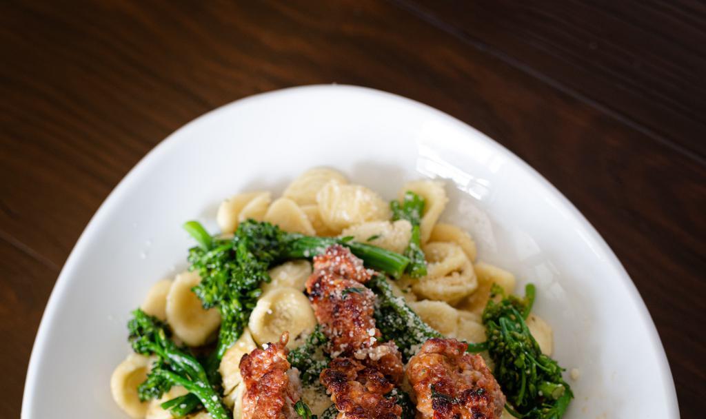 Sausage & Broccoli Rabe Orecchiette · Sweet and spicy sausage, sautéed with broccoli rabe, garlic, and over orecchiette in a white wine sauce and topped with shaved parmesan.