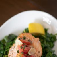Bruciato Salmon · Baked salmon filet topped with a lemon caper sauce over sautéed spinach.