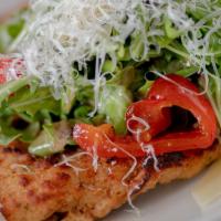 Chicken Milanese · Breaded cutlet topped with chopped arugula salad.