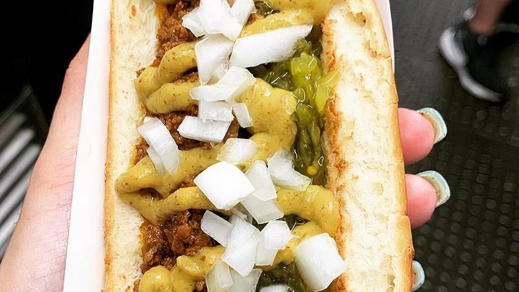 Hot Dog Complete · Hot dog with chili, relish, mustard and raw onions.