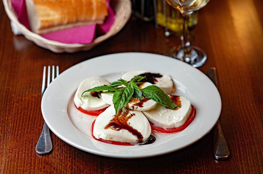 Mozzarella Caprese · Sliced fresh mozzarella, tomatoes and basil with balsamic glaze.