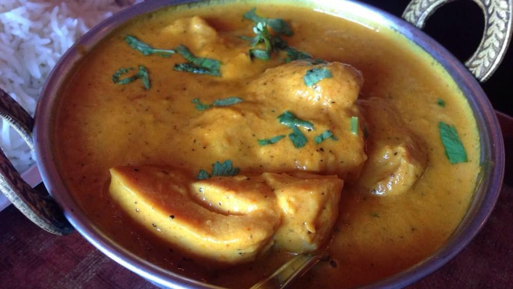 Chicken Dahiwala · Juicy pieces of chicken specially prepared with the chef's sharp knife, then simmered in a light sauce with yogurt, onions, tomatoes, and mild spices, a rare delicacy in northwest India.