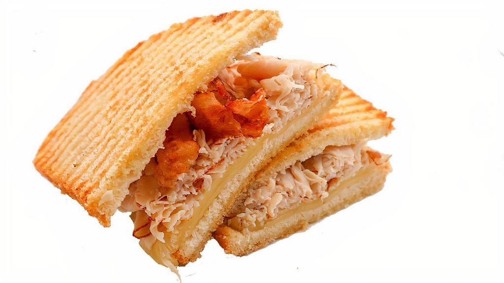 Turkey Club Panini · Our delicious panini bread toasted to perfection and made with cheese, turkey and crisped bacon.