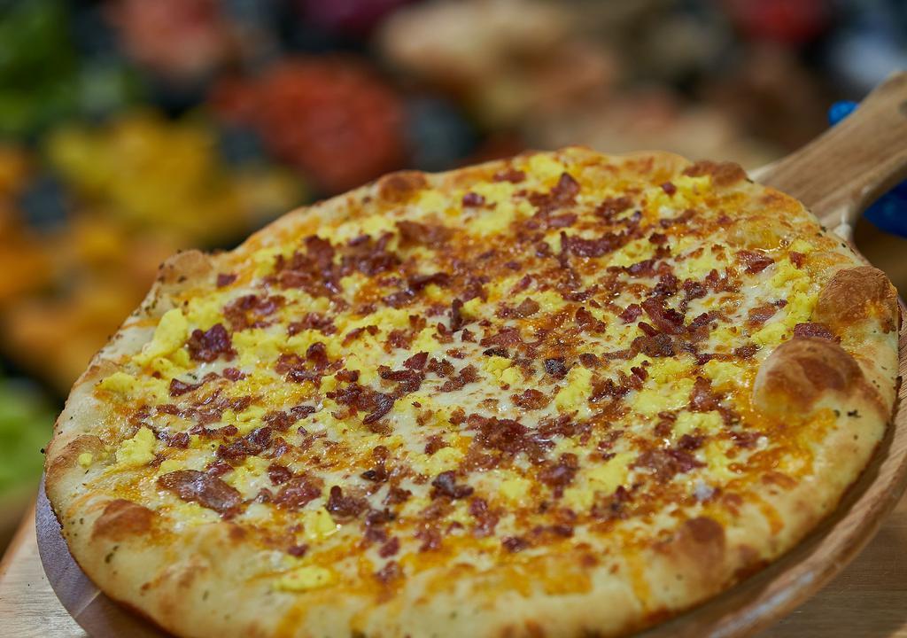 Breakfast Pizza · A breakfast like no other! Scrambled eggs with shredded cheddar and mozzarella cheeses. Your choice of meat: Bacon, Sausage or Ham.