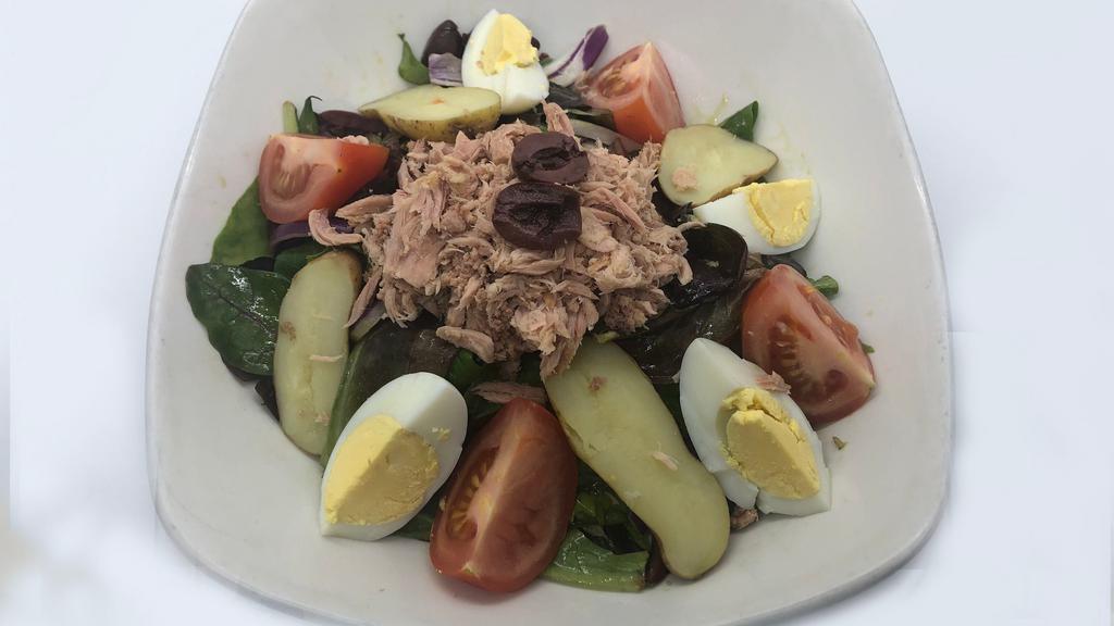 Salade Niçoise · Tuna in oil, calamata olives, onions, haricots verts, sliced potatoes, tomatoes, boiled egg, tarragon dressing