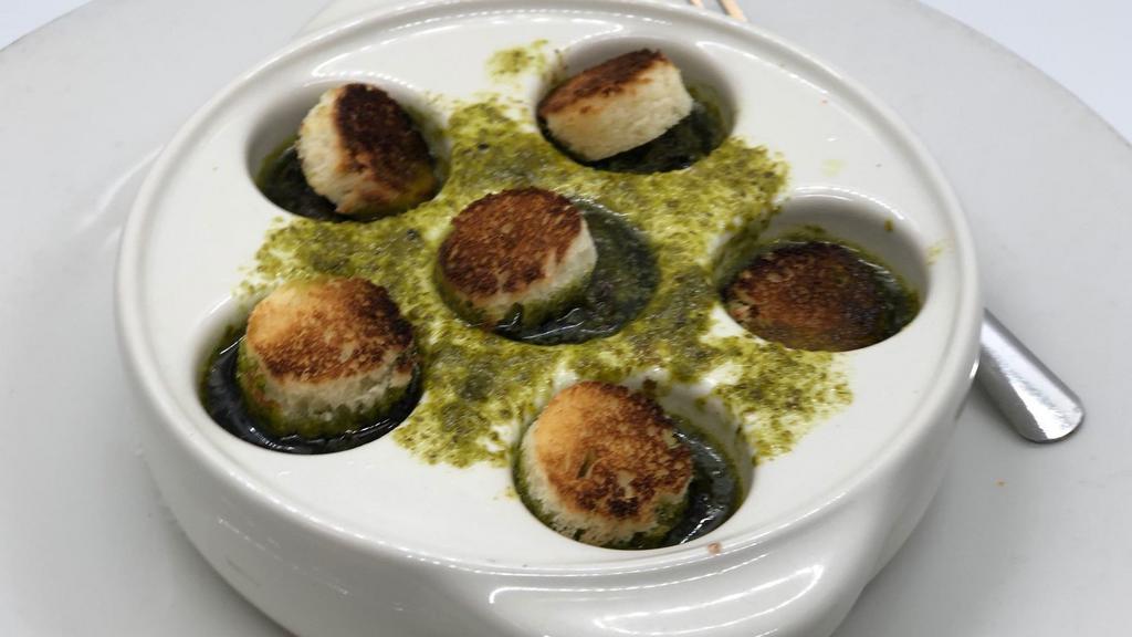 Escargots Persillée · Baked snails, garlic herb butter.