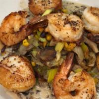 Coquilles Et Crevettes · Seared shrimp and scallops, oyster mushrooms, leeks, sweet corn fricasée, truffle cream sauce.