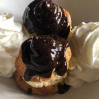 Profiteroles Au Chocolat · Cream puffs filled with vanilla ice cream and topped with warm chocolate sauce