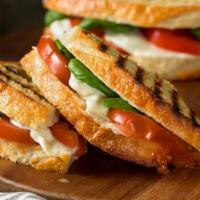 Veggie Mozzarella Panini · Panini filled with mozzarella, tomato, basil, spinach, avocado and balsamic vinegar.