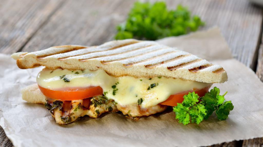Colonial Panini · Panini filled with chicken cutlet, mozzarella cheese, lettuce, tomato and 1000 island dressing.