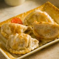 Pan-Fried Pork Dumplings · Minced pork wrapped in wheat wrappers. (4 pieces).