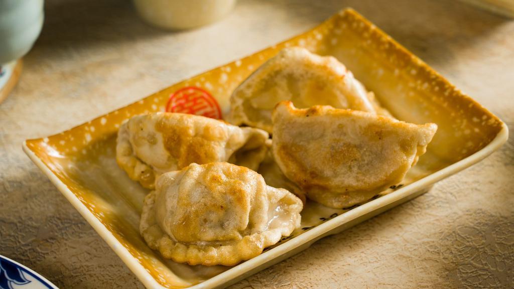 Pan-Fried Pork Dumplings · Minced pork wrapped in wheat wrappers. (4 pieces).