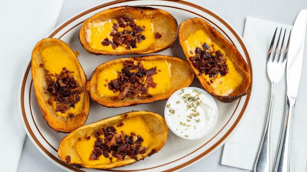 Potato Skins · 5 Jumbo skins topped with cheddar cheese and bacon.