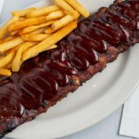 Baby Back Ribs · A full rack of our delicious fall-off-the-bone baby back ribs. Served with tossed salad, veg...
