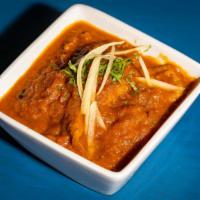 Goat Rogan Josh · Scallion pieces of goat in cardamom, aniseeds in a paprika sauce.