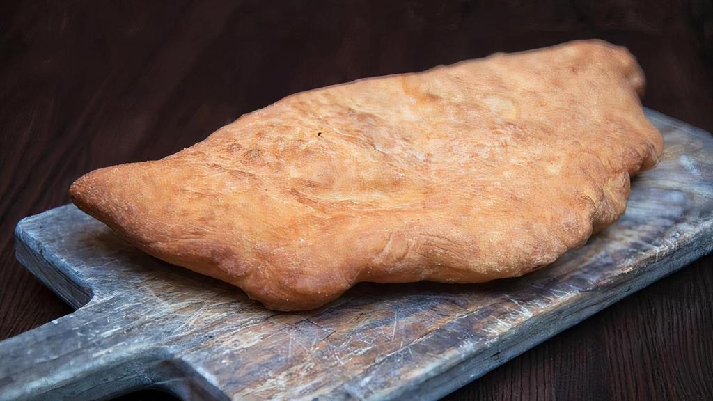 Calzone Fritto · Fried calzone filled with fresh mozzarella, fresh ricotta, cherry tomatoes and salame