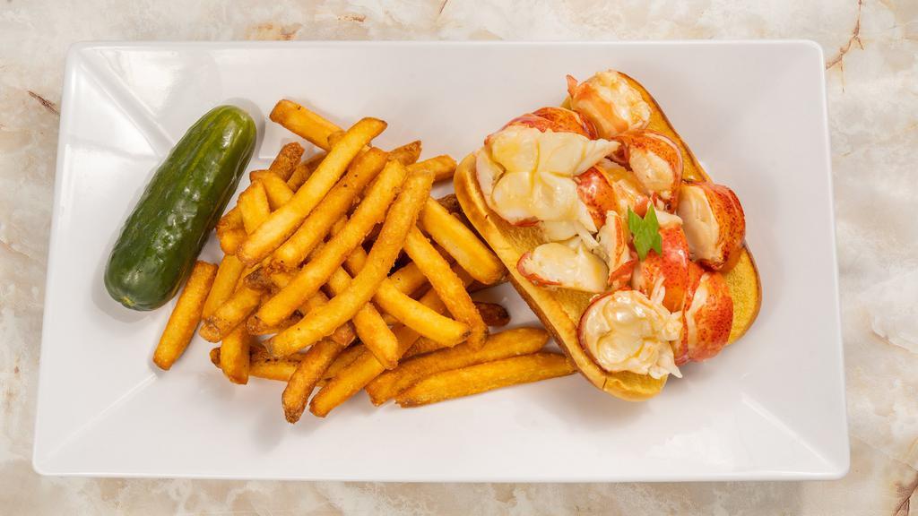 Connecticut-Style Lobster Roll · Fresh lobster meat poached in butter. Served with chips and a pickle.
