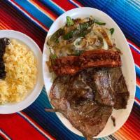Bistec A La Tampiqueña · Steak served with Mexican sausage. grilled onions. jalapeños, served with rice and beans.