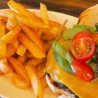 Jerk Burger With  Fries · Beef burger seasoned with Jerk seasoning, chedder cheese, fried onions, greens