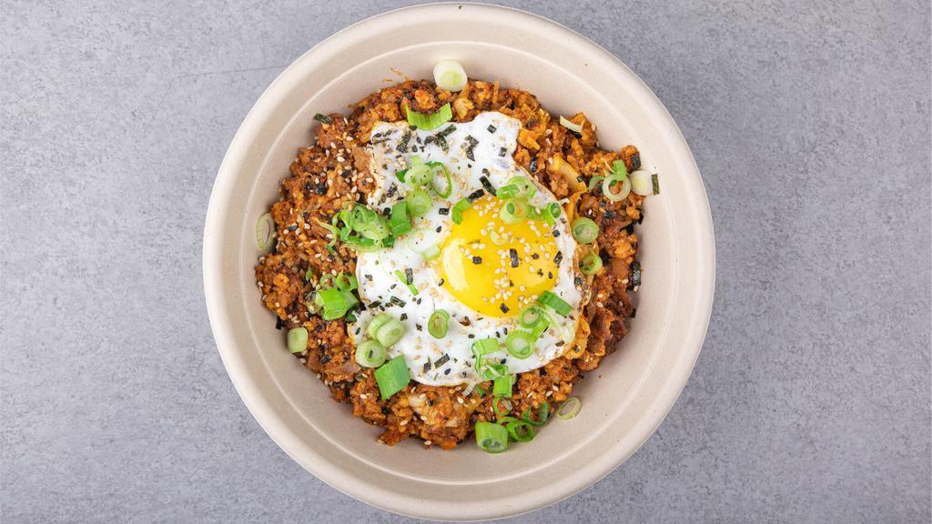 Kimchi Fried Rice (Spicy) · Fried rice with home made kimchi, spicy pork, seaweed strips, sesame seeds, and a sunny side up egg to top it off.