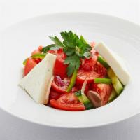 Tomato Salad · The authentic salad prepared with vine-ripened tomatoes