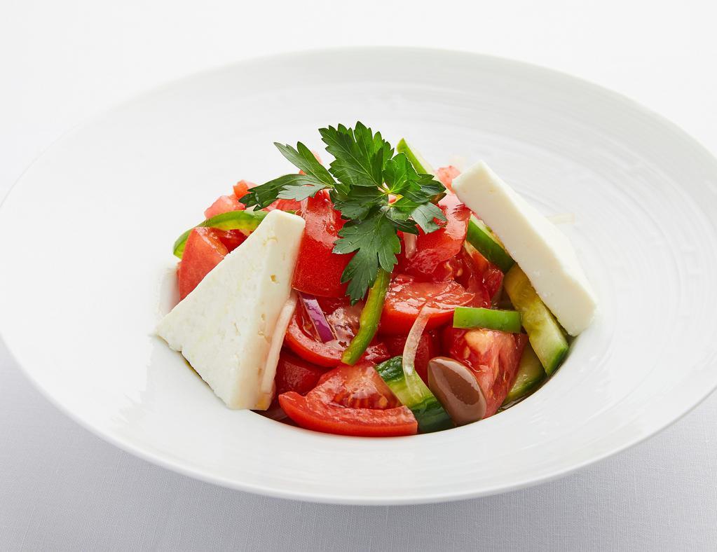 Tomato Salad · The authentic salad prepared with vine-ripened tomatoes