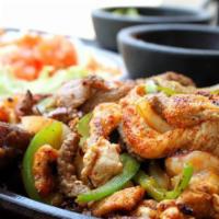 Mixed 2 Fajitas · Your choice of two styles. Served on a bed of onions and green peppers with guacamole, pico ...