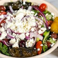 Mediterranean Salad · Fresh mixed greens, cucumbers, grape tomatoes, grape leaves, black olives, feta cheese, pepp...