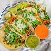 Tacos / Tacos · 4 tacos. Al pastor, tinga, pollo, asada, carnitas o carne enchilada. / 4 tacos. Marinated po...