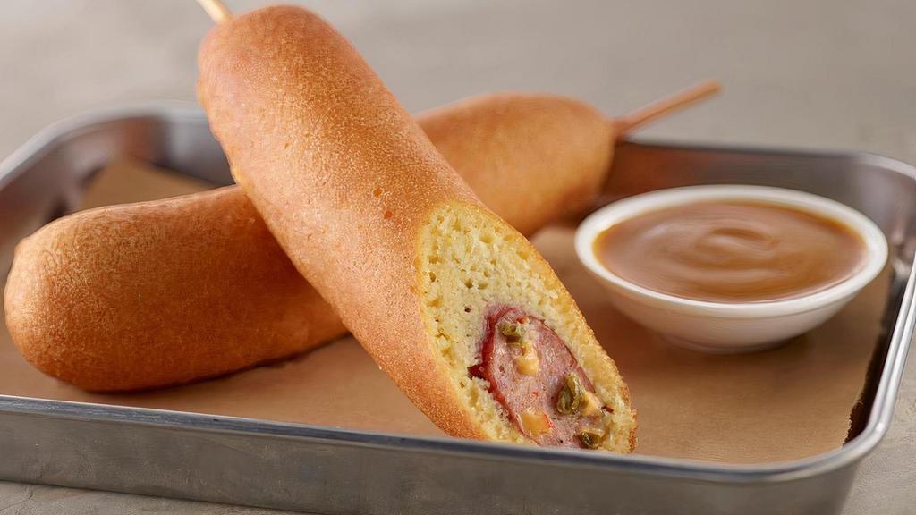 Jalapeno Cheddar Corndogs · Our jalapeno  and cheddar smoked sausage in cornmeal battered. Served with sweet and tangy mustard bbq sauce.