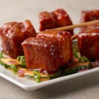 Korean Pork Belly Pops  · Our slow cooked, tender pork belly, flash fried until crispy topped with Korean BBQ sauce an...
