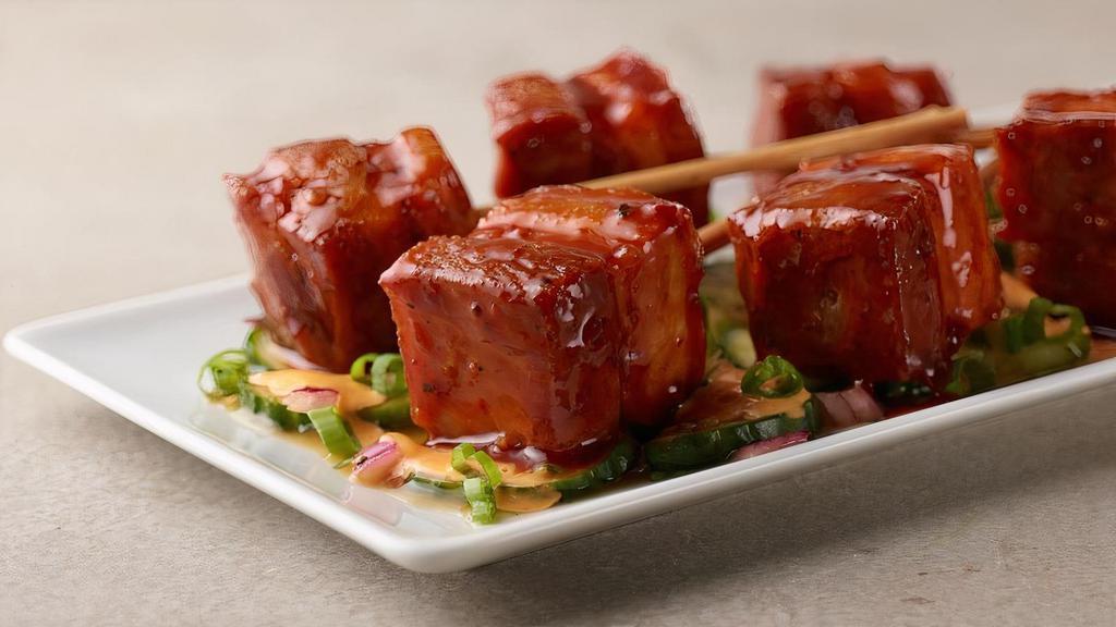 Korean Pork Belly Pops  · Our slow cooked, tender pork belly, flash fried until crispy topped with Korean BBQ sauce and served with fresh cucumber salad and a spicy mayo drizzle.