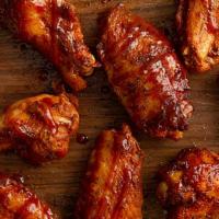 16 Jumbo Smoked Wings · House smoked wings tossed in your choice of sauce or dry rub. Get them the Bones Way, dusted...