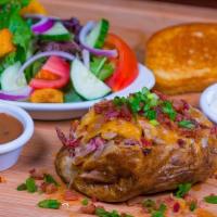 Stacked Baked Potato & Salad · Loaded baked potato topped with house smoked, hand pulled pork or Texas style beef brisket, ...