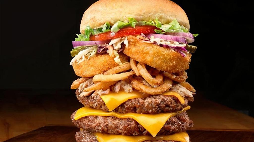 The Triple Stack Burger · Three half-pound patties, cheddar cheese, house smoked, hand pulled pork, onion rings, onion tanglers, and cole slaw. Served with your choice of 1 side.