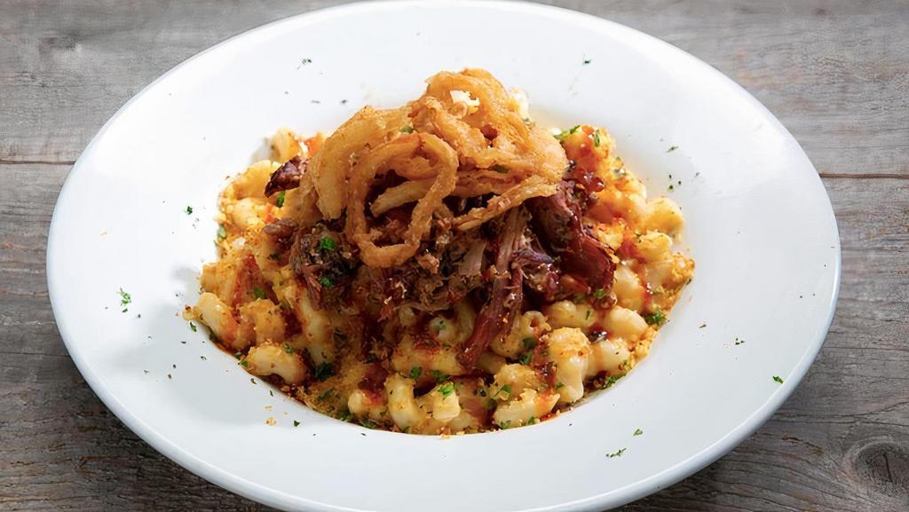 Smokehouse Mac · Smoked Gouda, Cheddar Jack, Cavatappi pasta, breadcrumb topping, parsely, topped with your choice of meat, onion tanglers and BBQ Sauce.