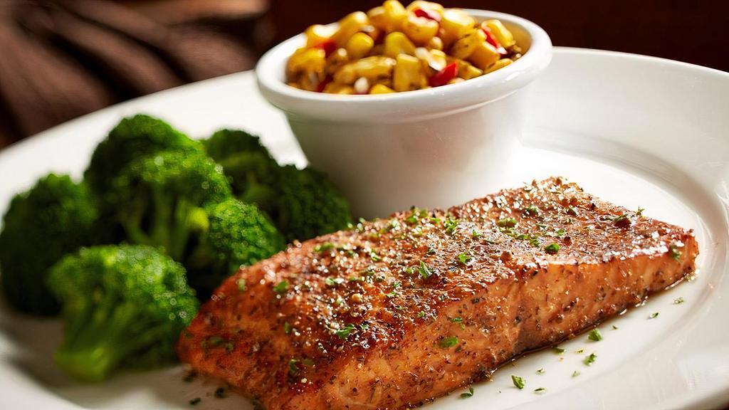 Fire Grilled Salmon · 7 oz Fire Grilled Salmon filet seasoned to perfection with a citrus butter sauce. Served with your choice of 2 regular sides and garlic bread.