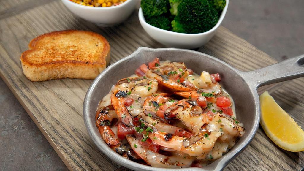 Fire Grilled Shrimp · Marinated shrimp, garlic butter, diced tomatoes, green onion, topped with lemon butter sauce and chopped parsley. Served with 2 regular sides and garlic bread.