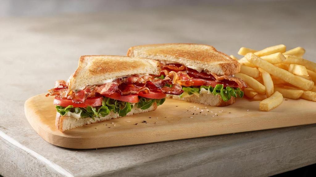 1/3 Lb Blt · 1/3 LB of our hardwood smoked bacon with vine ripened tomatoes and leaf lettuce, served on thick cut griddled bread with garlic herb mayo. Served with your choice of 1 side.