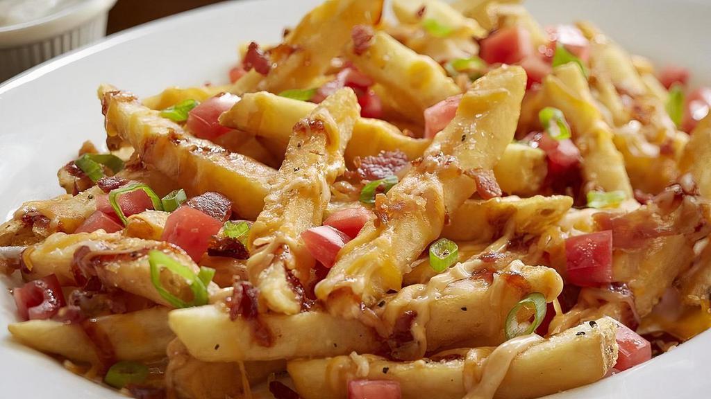 Loaded Cheese Fries · BBQ seasoning, Cheddar Jack cheese, bacon, chipotle mayo, BBQ glaze, diced green onions, tomatoes with buttermilk ranch. Upgrade to Family or Large. Family feeds 6-8 people, Large feeds 3-4 people.