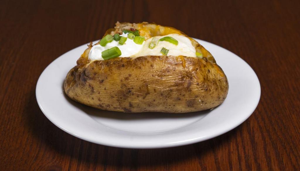 Loaded Baked Potato · Baked Potato loaded with Cheddar Jack cheese, bacon pieces, butter, sour cream and fresh green onions.