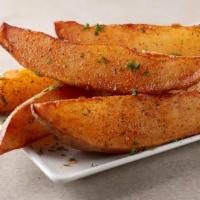 Potato Wedges · Crispy potato wedges tossed with our sweet and smokey dry
rub and topped with fresh parsley.