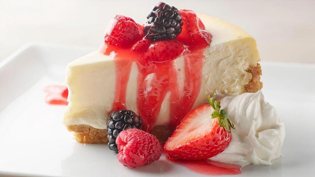 Mixed Berry Cheesecake · Rich & creamy cheesecake,  honey-graham cracker crust, strawberry sauce, mixed berries, whipped cream.