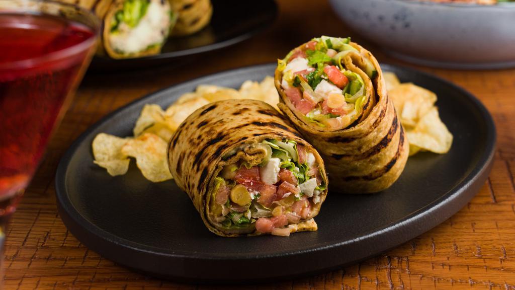 Mediterranean Chicken Wrap · Tomato, cucumber, chic peas, feta cheese, red wine vinaigrette,. sliced chicken, rolled in our homemade thin crusted grilled. bread.