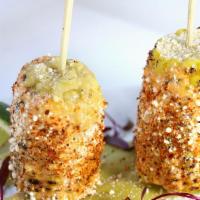 Elote · Grilled corn on the cob with chipotle mayo, cotija cheese & spicy chili.Gluten-Free. Vegetar...